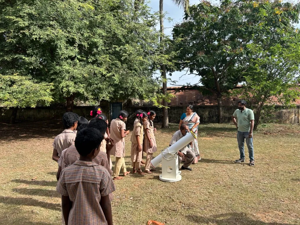 School students in uniform queued to observe the Sun through a telescope with safe solar filters during Chennai Astronomy Club outreach