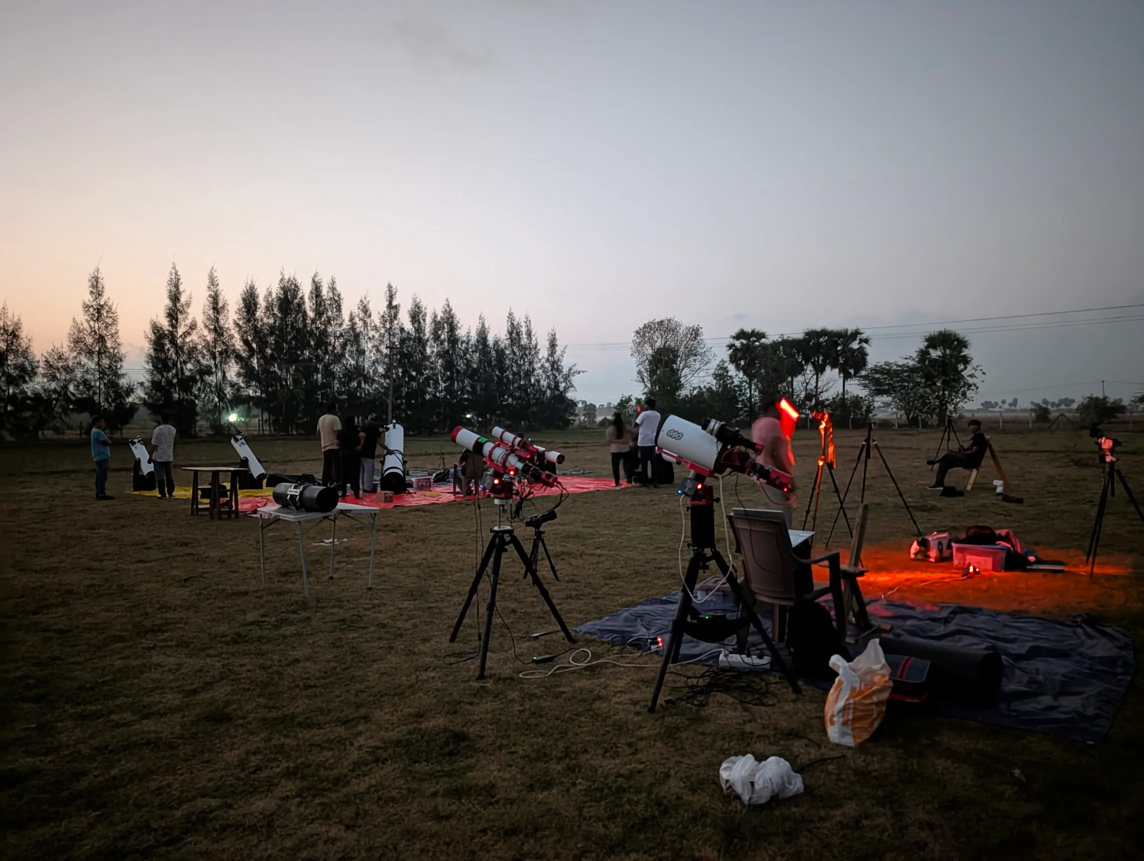 Members gathered around telescopes at an outdoor star party